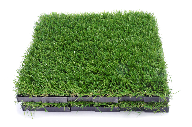 some tiles of artificial turf on a white background
