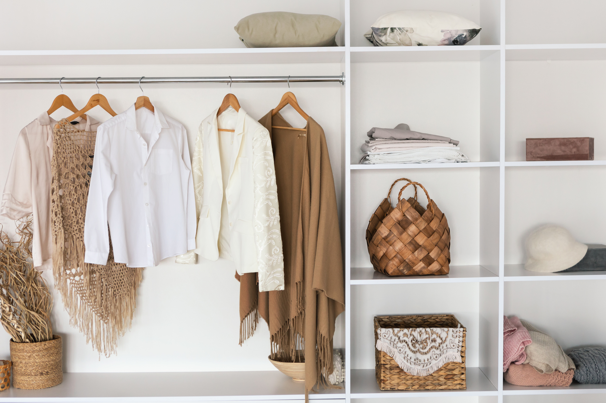Interior Of Spacious Wardrobe Room Full Of Female Clothes Hanging On Hangers And Accessories On Shelves Indoor. Closet With Trendy Outfits. Fashion Background, Modern Interiors Design. No People
